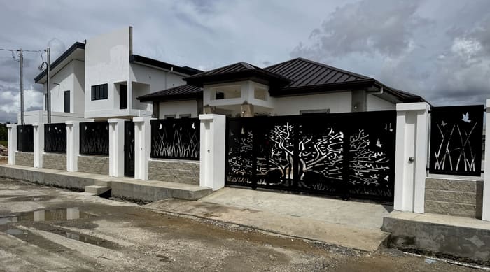 The full frontage of a property, with fencing and gates sharing one cut design